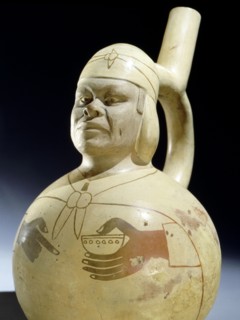 Mochica stirrup spouted portrait jar that uses an effective combination of modelling and painting to depict a real individual rather than a stylized person