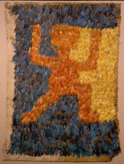 Featherwork tabbard with rampant monkey motif