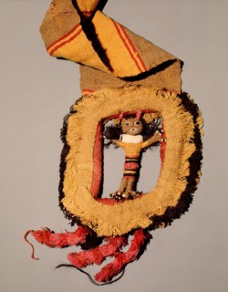 This elaborate belt shows a buckle made of tapestry in the form of a doll like figure