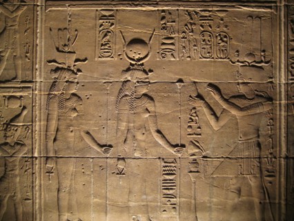 Relief depicting a pharaoh making offerings to the goddesses Isis and Hathor
