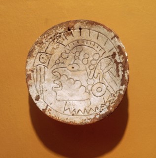 Shell gorget incised with a man with a Southern Cult headdress and ear plugs