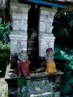 Divine gatekeepers at a small family temple dressed for a festival