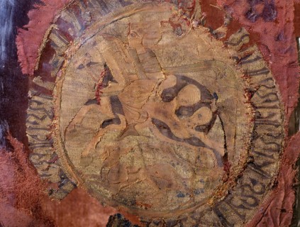 A fragment of a compound silk weaving depicting a horse and rider