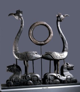 Sculpture of a pair of phoenixes resting on reclining tigers
