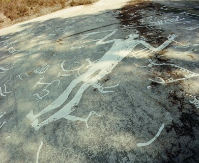 Near Litsleby, carved on top of older boats, is a man, larger than life, with an erect phallus and brandishing a spear
