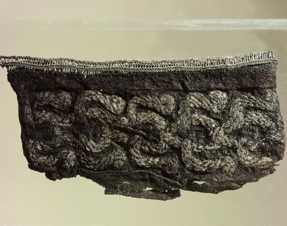Silk cuff embroidered with silver from a mans grave