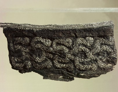 Silk cuff embroidered with silver from a mans grave
