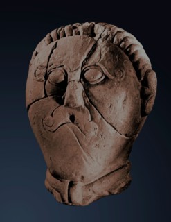 Male head in the La Tene style, found within a sacred enclosure and referred to as a warrior or a Celtic deity