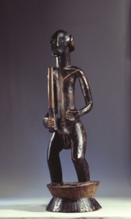 A male figure holding a club, on a flanged cylindrical base