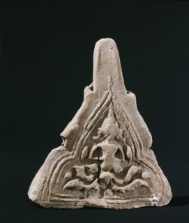A roof finial with a worn image of a Bodhisattva