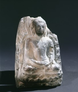 A fragment of a Buddha seated on a lotus blossom
