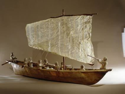 Model umiak with a helmsman and members of his family manning the oars