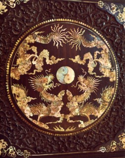 Mother of pearl inlay on a piece of dark wood furniture