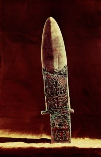 Ko axe with bronze handle and jade blade, incised with designs including an animal mask