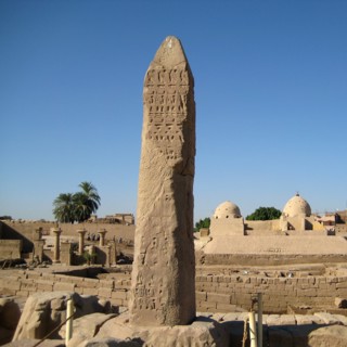 View of the ancient dock area of the Precinct of Amun with stela in the foreground and medieval Islamic buildings in the background