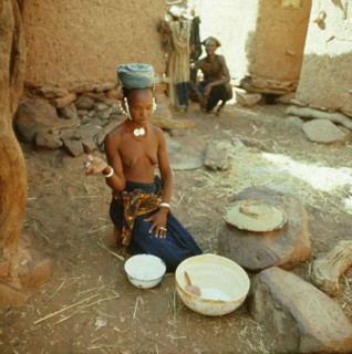 A Dogon woman gives thanks prior to commencing cooking