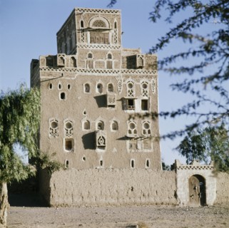 Multi-storeyed house with incised plasterwork and ornate window arches, in a village near San'a