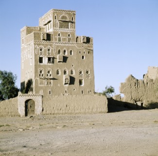 Multi-storeyed house with incised plasterwork and ornate window arches, in a village near San'a