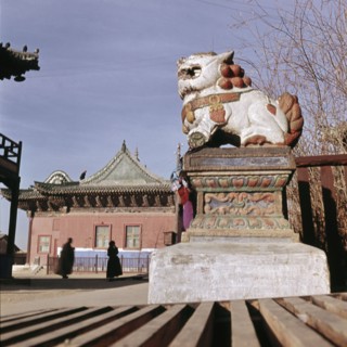 Statue of lion bearing silk threads attached by people asking favour