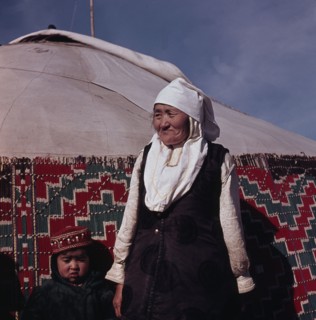 Mongolian woman in front of her yurt
