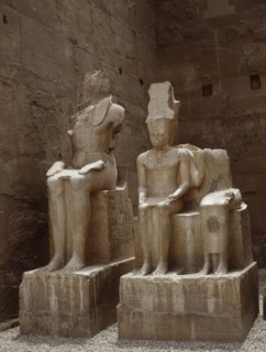 The South side of the processional colonnade of Amenophis III with seated double statues of the gods Amun and Mut