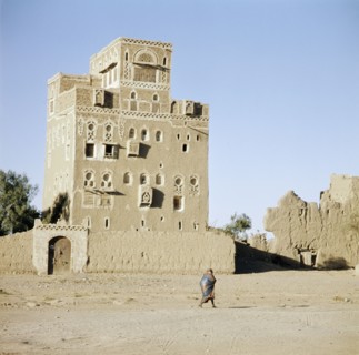 Multi-storeyed house with incised plasterwork and ornate window arches, in a village near San'a