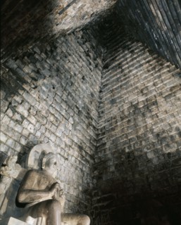 A statue of the seated Buddha in Chandi Mendut, one of the several temples associated with Borobudur