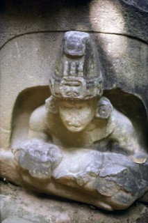 Olmec ruler in a stylised Jaguar mouth cave holding a baby deity