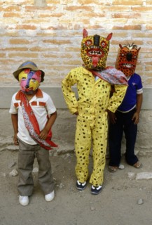 Two young boys dressed as Jaguars and one as a Fox, in the fertility and rain making festival dating from the pre-Columbian times