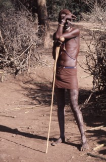 The hairstyle and beadwork of this Masai man indicate his status as a warrior