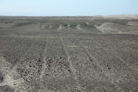 Parallel Nazca lines converging on / radiating out of a small hill