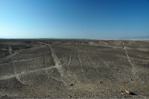 Nazca lines of varying widths converging on / radiating out of a small hill