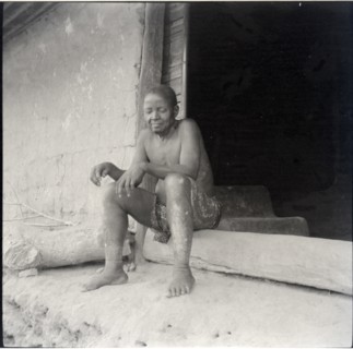[Eus Sere?] sitting in doorway