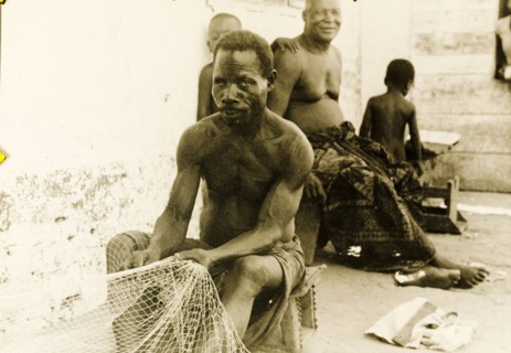 Fisherman repairing his nets, Ghana