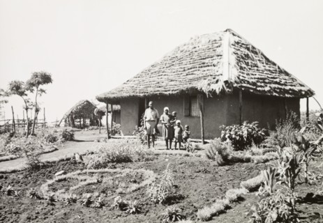 A Kikuyu family outside their home
