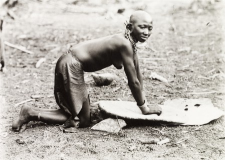Kikuyu woman grinding millet