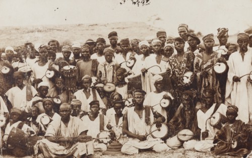 Group of dancers and tom-tom drummers posing for the camera
