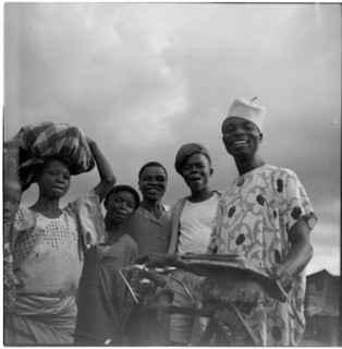 Ibadan: Town and market, group of men with bicycle