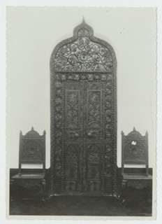 Carved doorway and two chairs