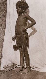 Portrait of a young girl dressed in a grass skirt