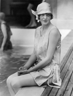 Young Woman Sitting By Pool