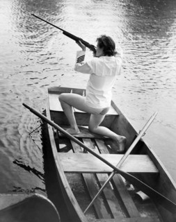 Woman Firing A Rifle