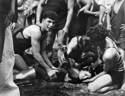 Lifeguard Resuscitating Woman
