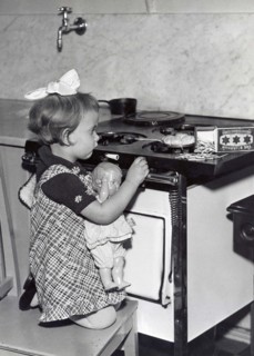 Girl And Doll In Kitchen