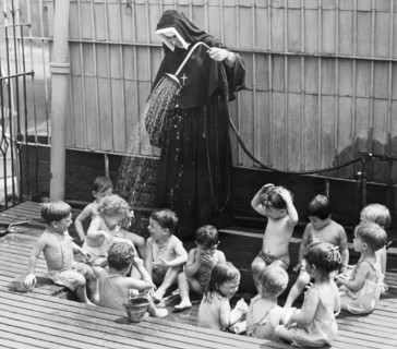 A Nun Watering Children