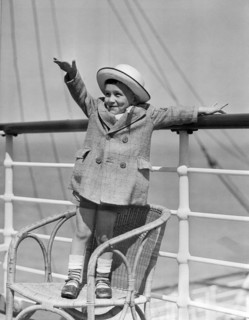 Boy Waving On Ocean Liner