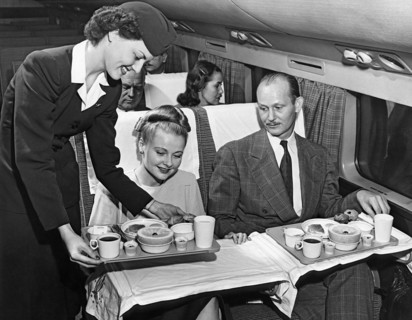 A Stewardess Serving Breakfast