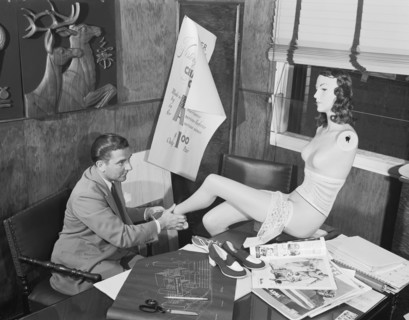 Man Adjusting A Mannequin