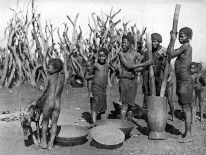 African Girls Grinding Corn
