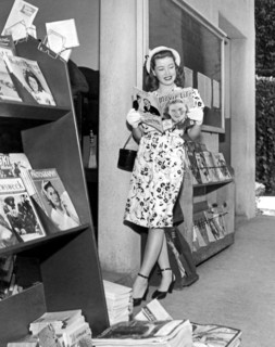 A Woman At A Magazine Stand